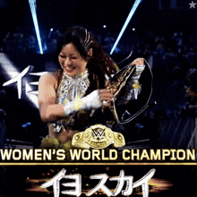 a woman holding a world championship belt with the words women 's world champion written below her