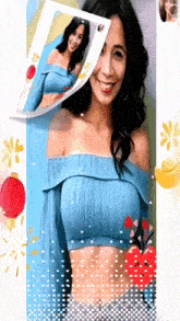 a woman in a blue off the shoulder top is surrounded by red lanterns .