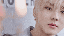 a close up of a person 's face with a blurry background and a sign that says ' u ' on it
