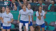 a group of female athletes wearing france jerseys celebrate