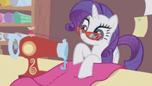 a cartoon pony wearing sunglasses is sewing a piece of fabric