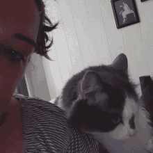 a woman is taking a selfie with a cat