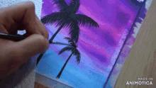 a person is painting palm trees on a purple and blue background