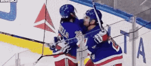 a hockey player with the number 36 on his jersey hugs another player