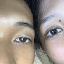 a close up of a woman 's eyes next to a man 's eyes