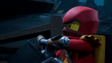 a lego figure with a red headband and a sword