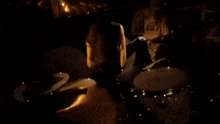 a man playing drums in a dark room with a drum set that says sabian on it
