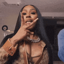 a woman with long black hair is wearing a gucci purse
