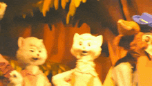 a group of stuffed animals are standing next to each other with one wearing a blue hat