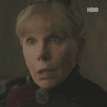a close up of a woman 's face with a hbo logo in the background