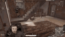 a man wearing headphones is playing a video game while sitting in a chair .