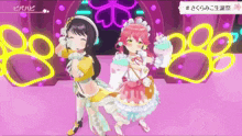 two anime girls are standing next to each other on a stage with paw prints in the background