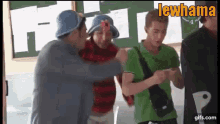 a group of people are standing in front of a green board that says lewhama on it
