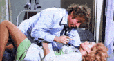 a man and a woman are having sex on a bed in a room .