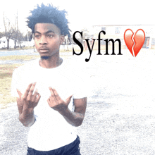 a young man stands in front of a sign that says syfm on it