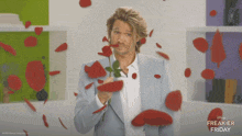a man holding a rose with petals falling around him and the words freakier friday