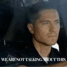 a man in a car with the words " we are not talking about this "