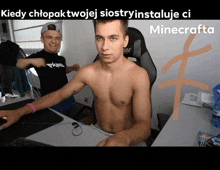 a shirtless man sits at a desk next to another shirtless man who is wearing a black shirt that says ekipa
