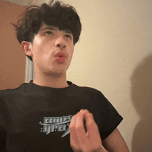 a young man wearing a black t-shirt that says bmp on it
