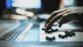 a close up of a person 's hands pressing a button on a keyboard