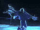 a man in a suit is standing behind a couple of ice skaters