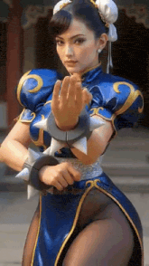 a woman dressed as chun li from street fighter is holding a sword .