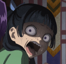 a close up of a girl 's face with a surprised look on her face
