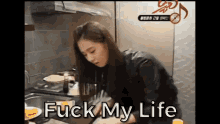 a woman is cooking in a kitchen and the words fuck my life are visible