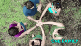 a group of women are sitting in a circle putting their hands together with the words one family written above them