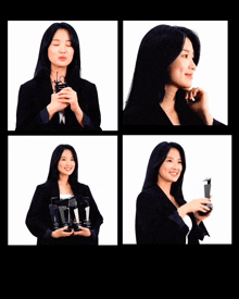 a woman in a black jacket is holding a trophy and smiling