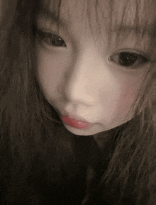 a close up of a girl 's face with a red lip