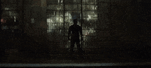 a man with a beard stands in front of a window and says hello there