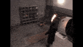 a man in a black coat is standing in a dark room with a fireball in his hand