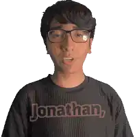 a man wearing glasses and a shirt that says jonathan on it