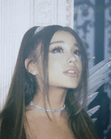 a close up of a woman 's face with a choker around her neck