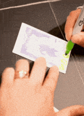 a person is writing on a piece of paper with a marker that says ' i love you ' on it