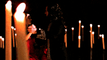 a woman in a red dress is standing next to a man in a black suit