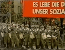 a group of soldiers marching in front of a banner that says es lebe die d unser sozia