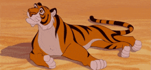 a cartoon tiger is laying on its back on a sandy surface