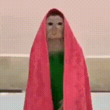 a statue of a woman is wrapped in a pink blanket