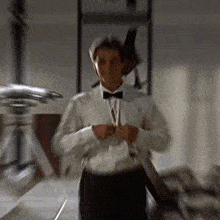 a man in a white shirt and black bow tie