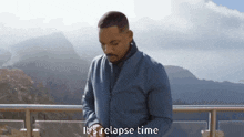 a man standing on a balcony with the words it 's relapse time written on the bottom