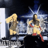 a group of women dancing on a stage with the name matedodo on the bottom right
