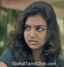 a close up of a woman 's face with the website globaltamilchat.com written on the bottom