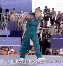 a woman is dancing in front of a crowd with the words `` the pleasure was all mine '' written on the screen .