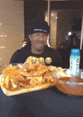 a man sitting at a table with food and a bottle of care deodorant