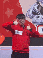 a man in a red jacket and glasses is giving a thumbs up sign .