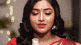 a woman with red lipstick and a nose ring