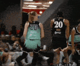 a female basketball player wearing a number 20 jersey
