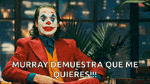 a man in a clown costume is sitting in front of a window and says murray demuestra que me quieres !!!